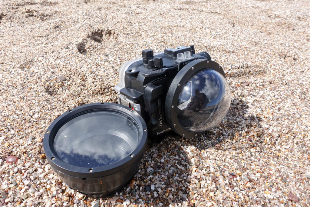 The Sea Frogs Salted Line lens ports are compatible with the RX1xx housing, this is the 4" dome on the housing and standard flat port on the sand